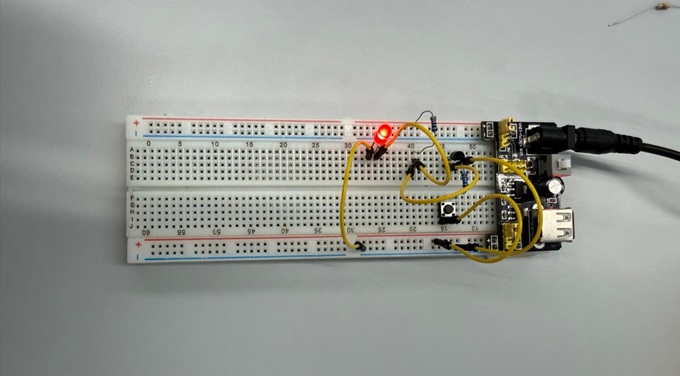 NOT gate circuit on a breadboard with wiring, switches, and an LED indicating output